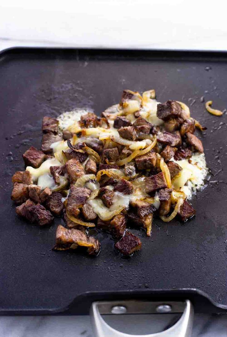 the food is being prepared and ready to be cooked on the grilling sheet with tongs