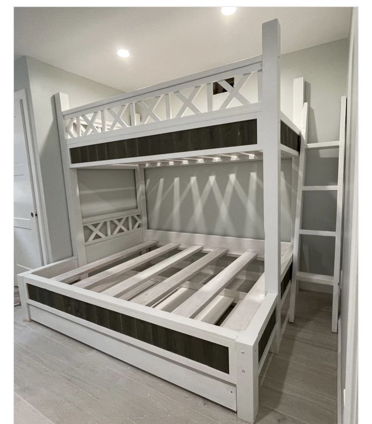 a white bunk bed sitting in the middle of a room