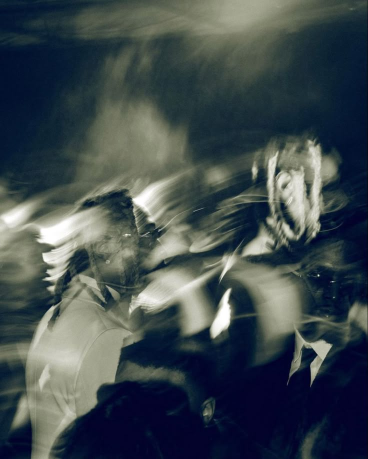 black and white photograph of people walking in the rain