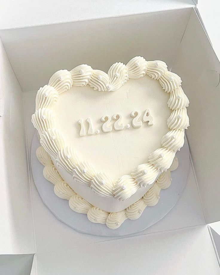 a heart shaped cake in a white box