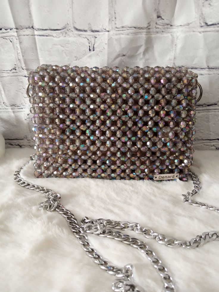 Dazzling nights call for an exquisite companion. This beaded evening bag adds the perfect touch of glamour to your ensemble. Dimension: Width: 18cm Height: 13cm Depth: 6cm The bag comes with two detachable handles. Feel free to contact me for any questions. Evening Handheld Beaded Clutch, Glamorous Beaded Rectangular Evening Bag, Beaded Handheld Evening Bag For Party, Glamorous Beaded Clutch Evening Bag, Glamorous Rectangular Beaded Evening Bag, Glamorous Beaded Evening Bag, Glamorous Evening Bag With Chain Strap For Gift, Rectangular Sparkling Evening Clutch, Glamorous Beaded Evening Clutch