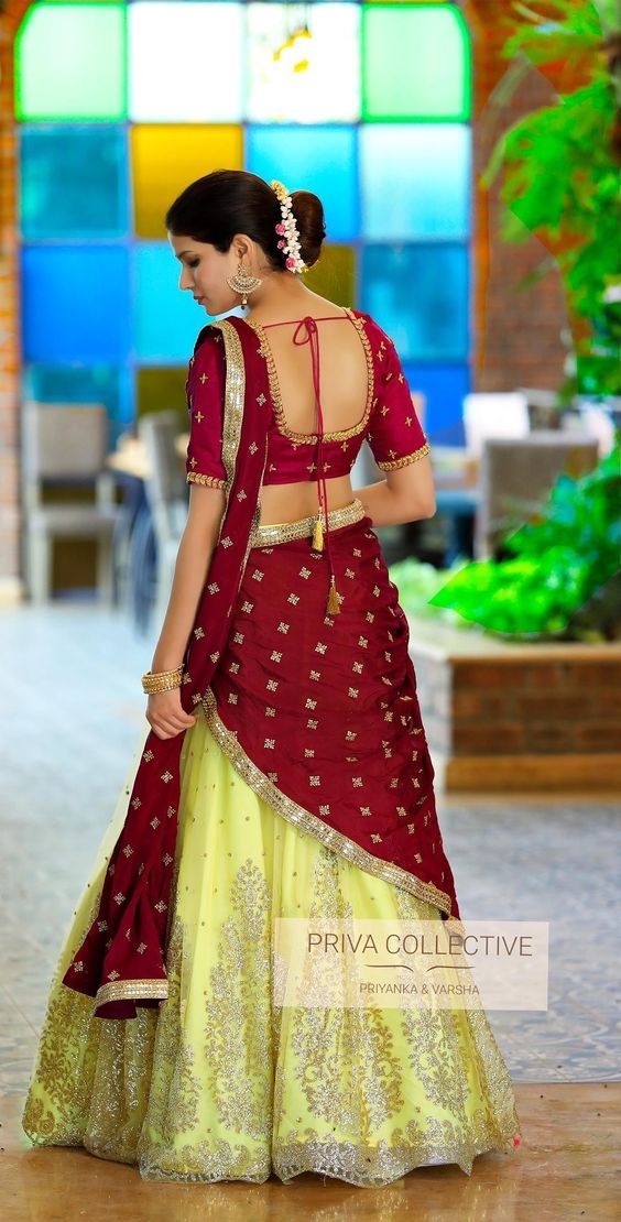 a woman in a red and yellow lehenga