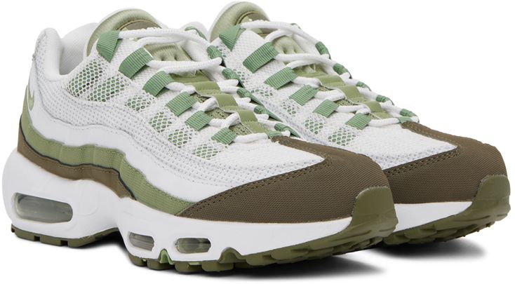 Low-top paneled mesh, buffed leather, and jersey sneakers in green and white. · Lace-up closure · Logo flag at padded tongue · Padded collar · Swoosh embroidered at outer side · Logo embossed at heel tab · Mesh lining · Air sole unit at sculptural rubber midsole · Treaded rubber outsole Please note that this item may be shipped only within North America. Supplier color: White/Medium olive/Oil green Green High-top Sneakers With Rubber Waffle Outsoles For Sports, Green High-top Sneakers With Textured Sole, Green Sporty Sneakers With Textured Sole, Green Sports Sneakers With Textured Sole, Green Sneakers With Textured Sole For Sports, Nike Sale, Nike Air Max 95, Nike Green, Air Max 95