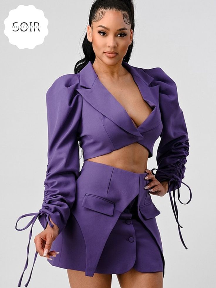 Introducing our Regal Orchid Fringe Elegance Set – a captivating ensemble that effortlessly combines modern sophistication with playful flair. This stunning two-piece set features a striking cropped blazer and a coordinating skirt, both adorned in a regal shade of purple. The blazer takes center stage with a deep V-cut, adding a touch of allure to the ensemble. The cuffs of the blazer are adorned with fringes, providing a unique and customizable element to your look. These fringes can be tied in Blazer Skirt Set, Black Jumpsuit Dress, Black Cutout Dress, Blazer And Skirt Set, Purple Long Sleeve, Purple Skirt, Blazer And Skirt, Classic Blazer, Curvy Dress