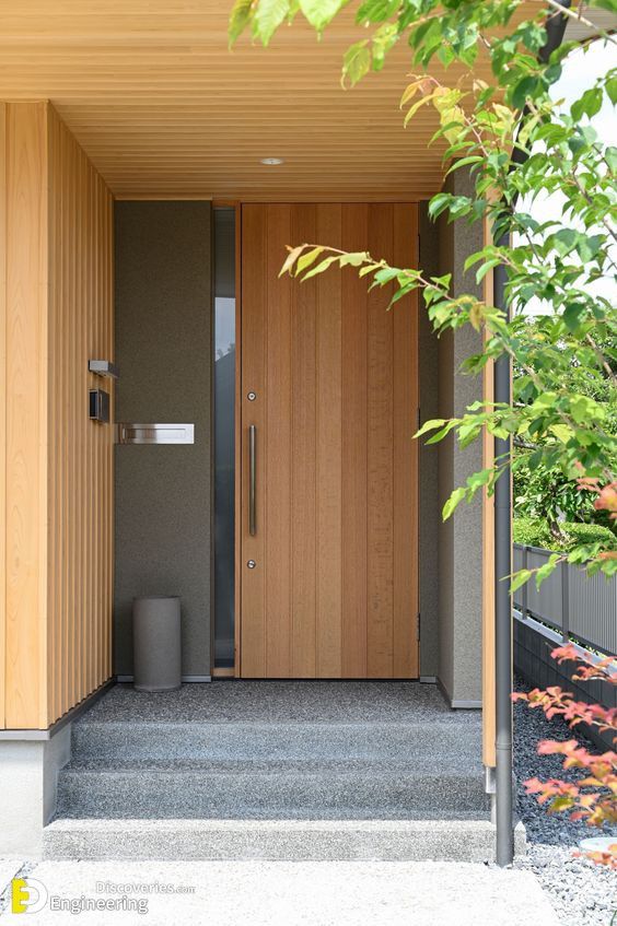 an entrance to a house with wooden doors