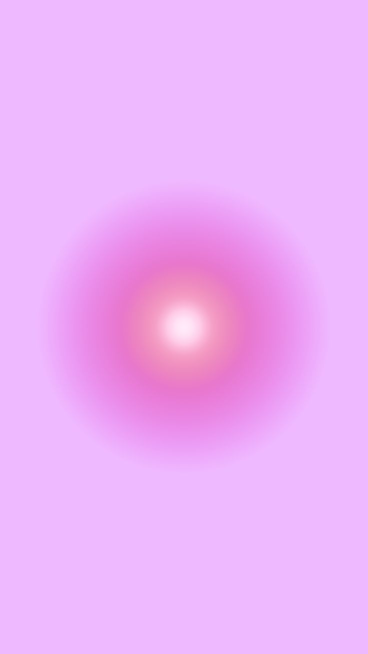 a blurry image of a pink circle in the middle of a light purple background