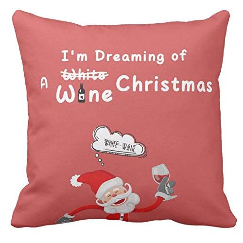 a red pillow with a santa clause holding a wine glass in it's hand