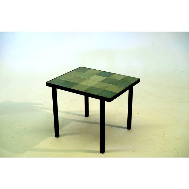 a green table with black legs on a white background