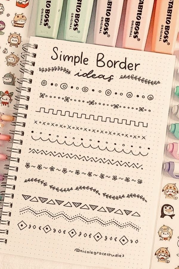 a notebook with some writing on it next to markers and pencils that say simple border