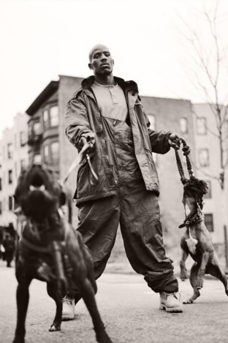 a man is walking two dogs in the street