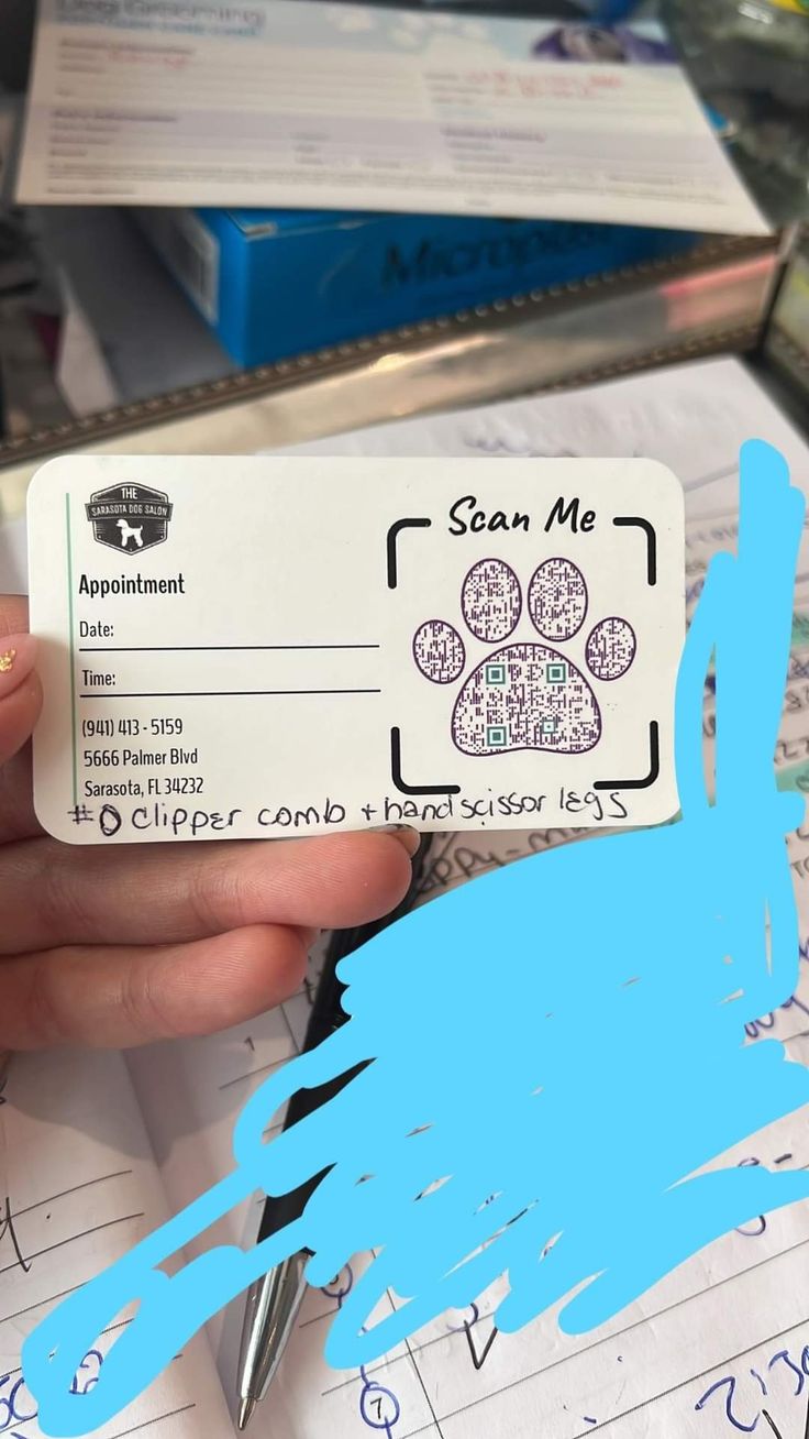 someone is holding up a business card with their dog's paw print on it