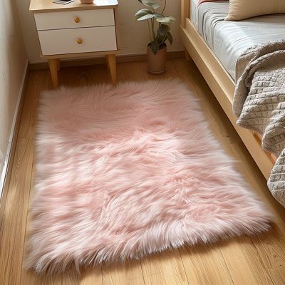 a bedroom with a pink rug on the floor