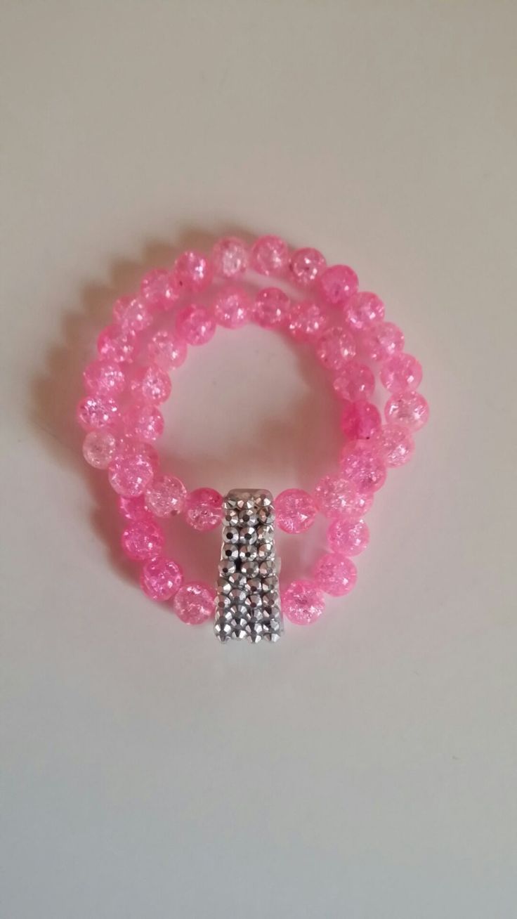 Stunning hot pink glass beads with a shattered look connected to a rhinestone focal piece. The perfect double banded stretch cord bracelet. Party Jewelry Bracelet With 8mm Beads, Party Bracelet With 8mm Beads, Pink Crystal Bracelets For Party, 8mm Beaded Bracelet For Parties, Pink Beaded Crystal Jewelry, Pink Crystal Bracelet With Rhinestones, Elegant Pink Bling Bracelets, Pink Crystal Bracelet With Round Beads, Pink Crystal Bracelets With Round Beads