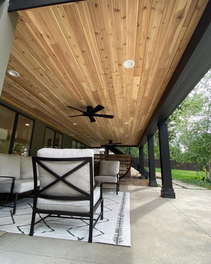 an outdoor living area with furniture and a ceiling fan