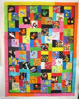 a colorful quilt hanging on the wall