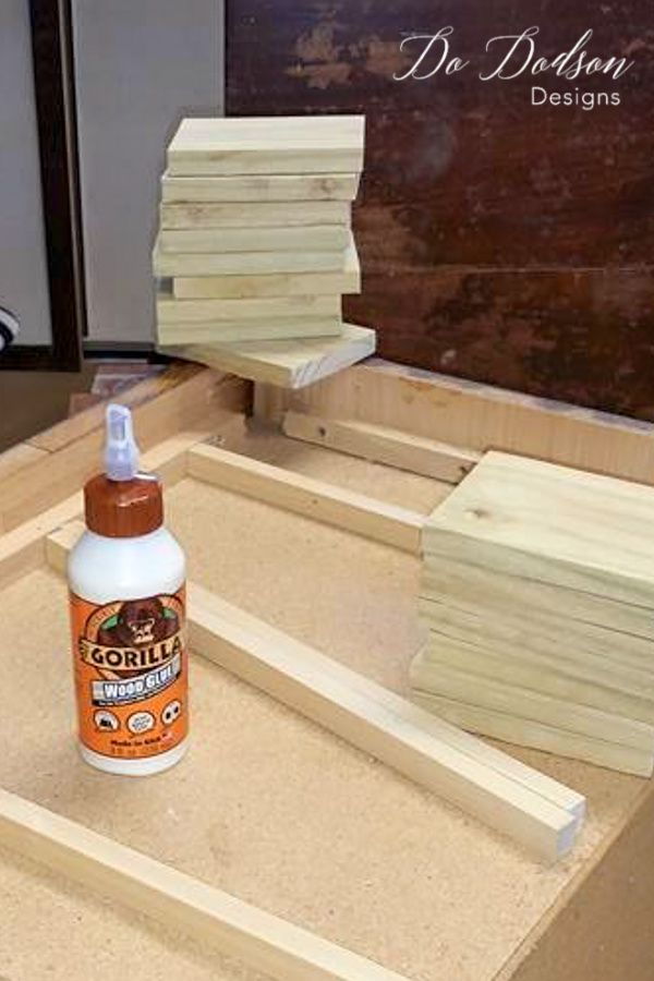 a bottle of glue sitting on top of some wood