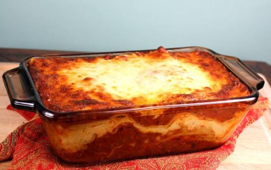 a casserole dish is sitting on a red cloth