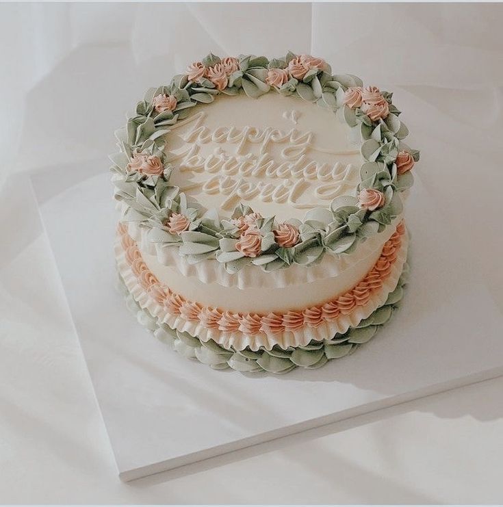 there is a wedding cake on top of the table with flowers and leaves around it