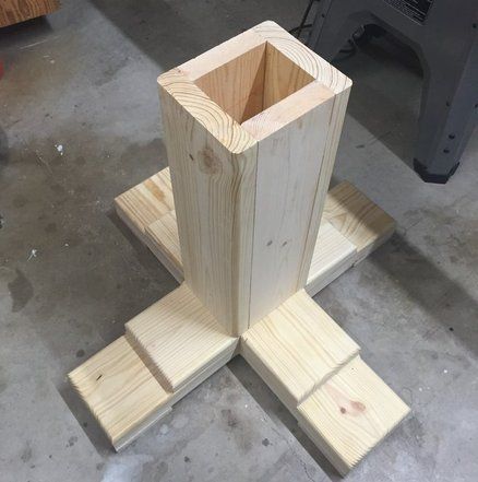 a wooden object sitting on top of two pieces of plywood