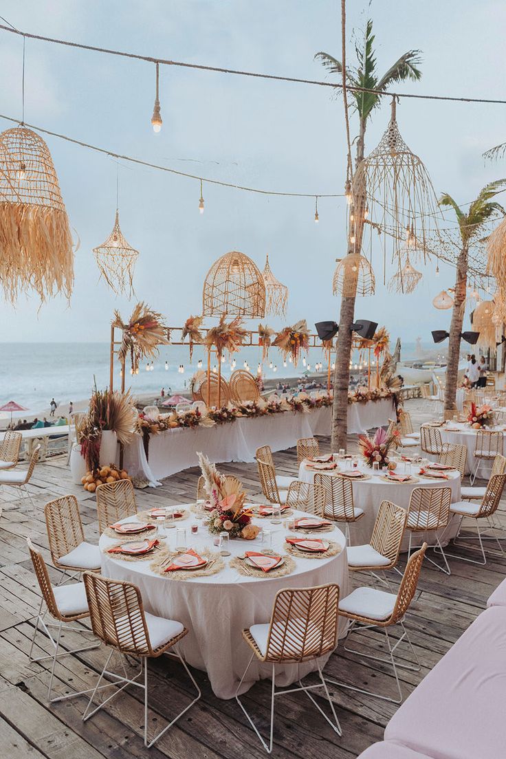 an outdoor dining area with tables and chairs set up for a wedding or special event