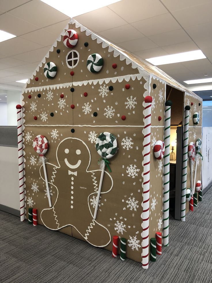 an office cubicle decorated with gingerbread and candy canes