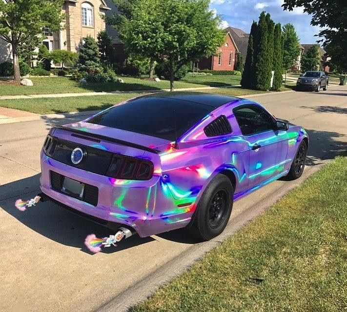 a car that is parked on the side of the road with holographic paint