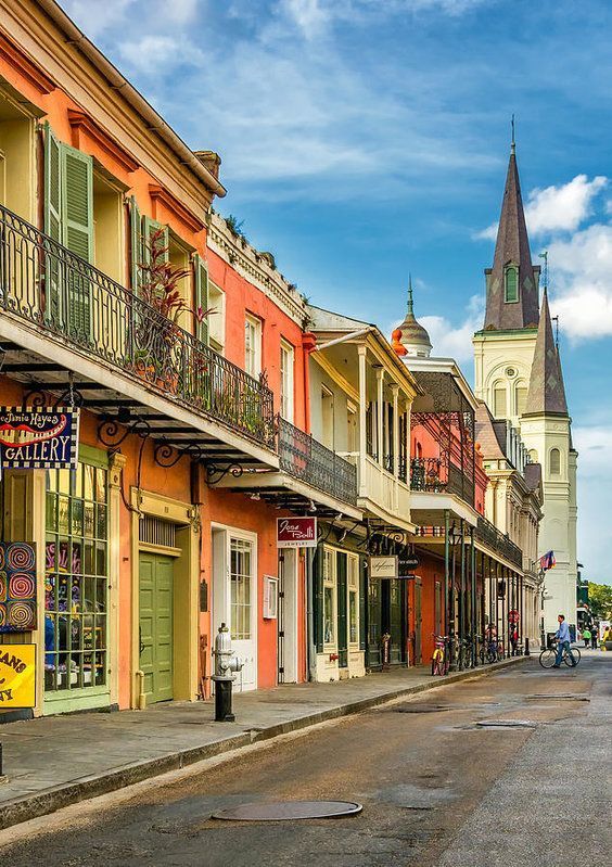 an empty city street lined with colorful buildings