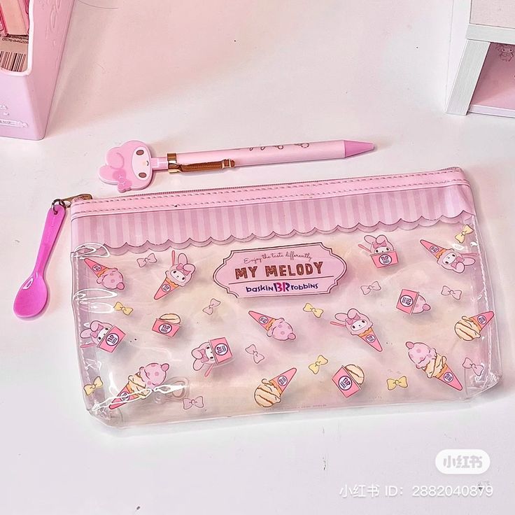 a pink pencil case sitting on top of a white table next to a pink toothbrush