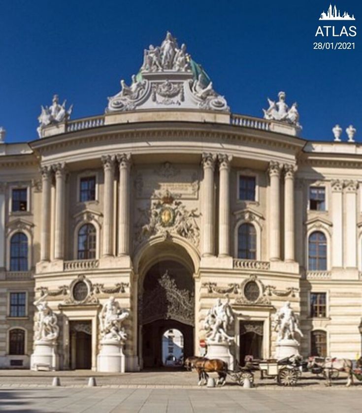 a large building with statues on the front and side of it's entrance door