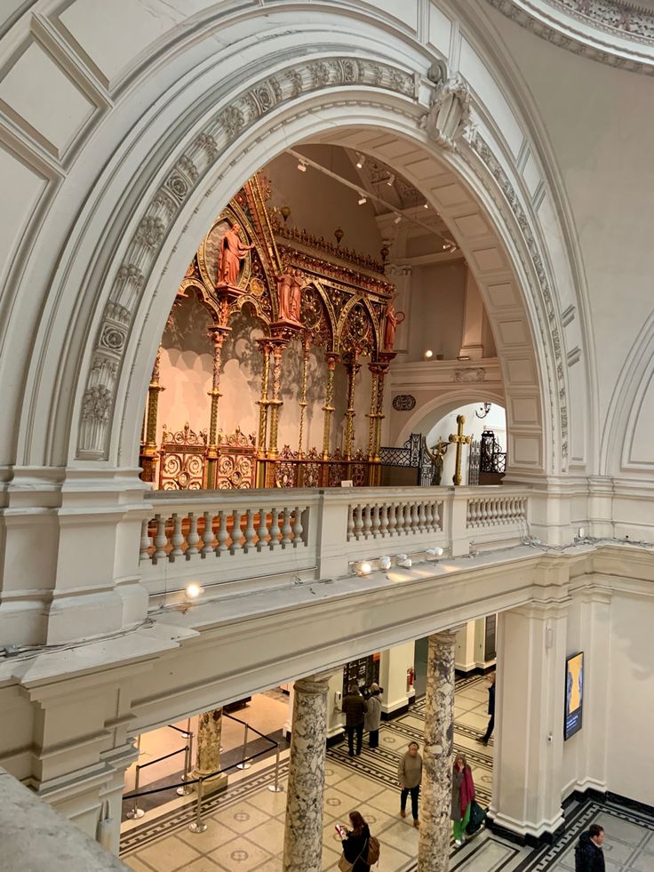 the inside of a building with people walking around