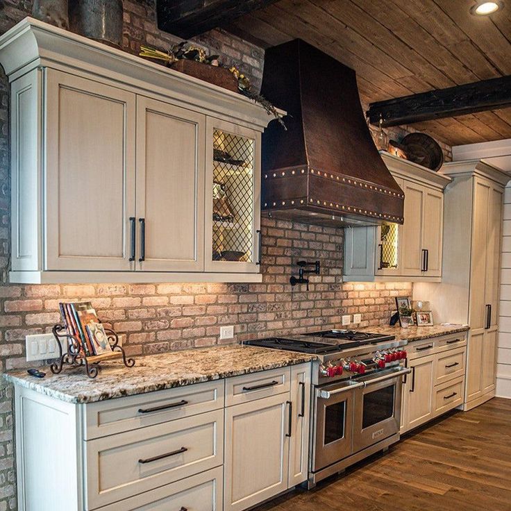 a kitchen with an oven, stove and sink in it's center island area