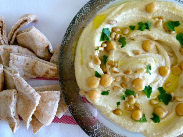 hummus and pita chips on a plate