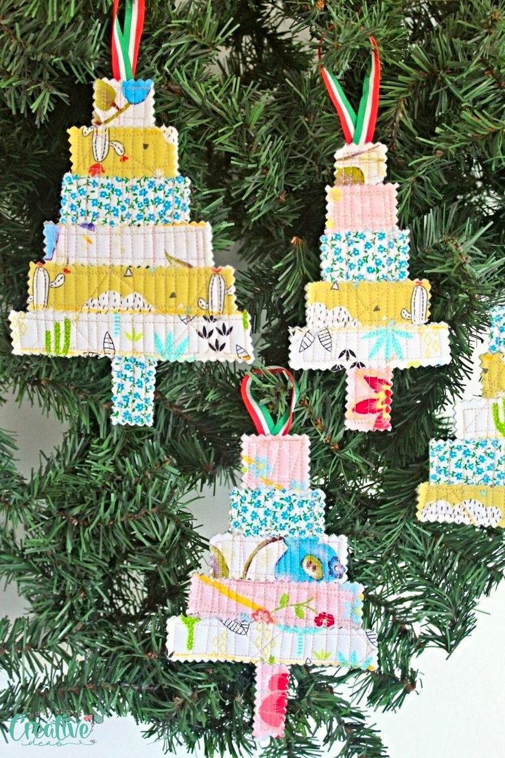 three christmas ornaments hanging from a tree