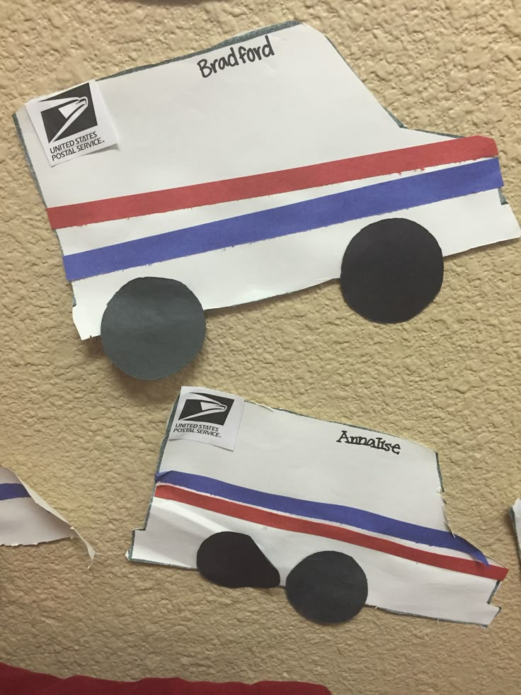 paper cars are cut out and placed on the wall