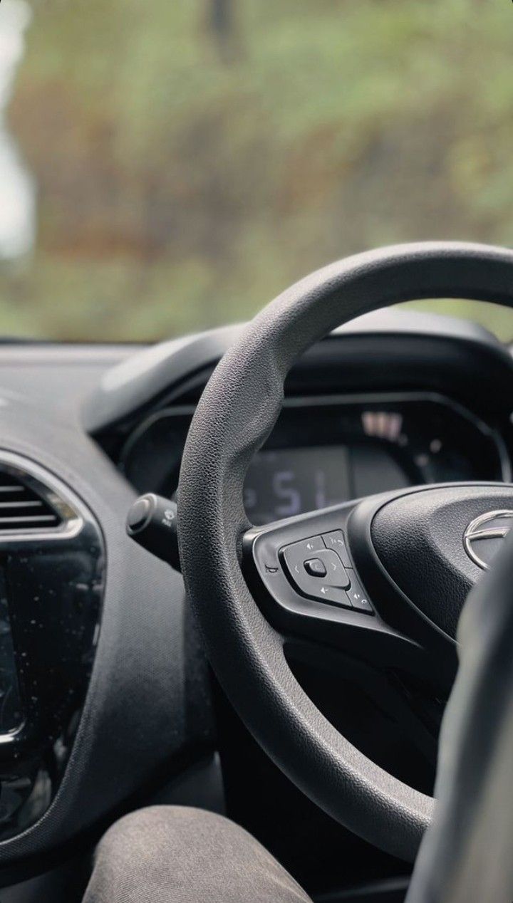 the interior of a car with steering wheel, dashboard and air vent in front of it