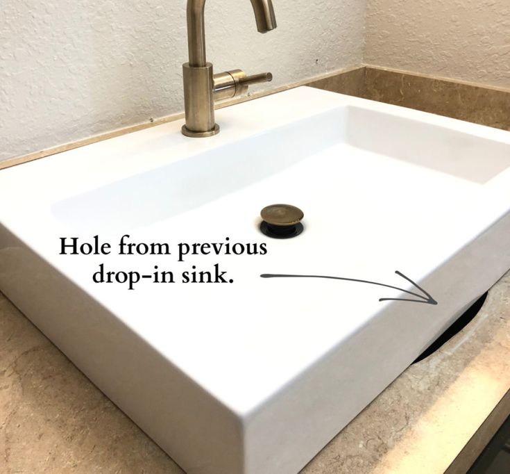 a bathroom sink with holes in the bottom and an arrow pointing to hole from previous drop - in sink