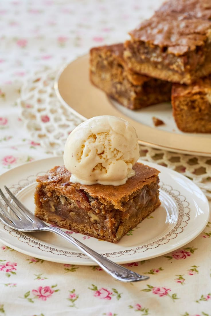 a piece of cake on a plate with ice cream