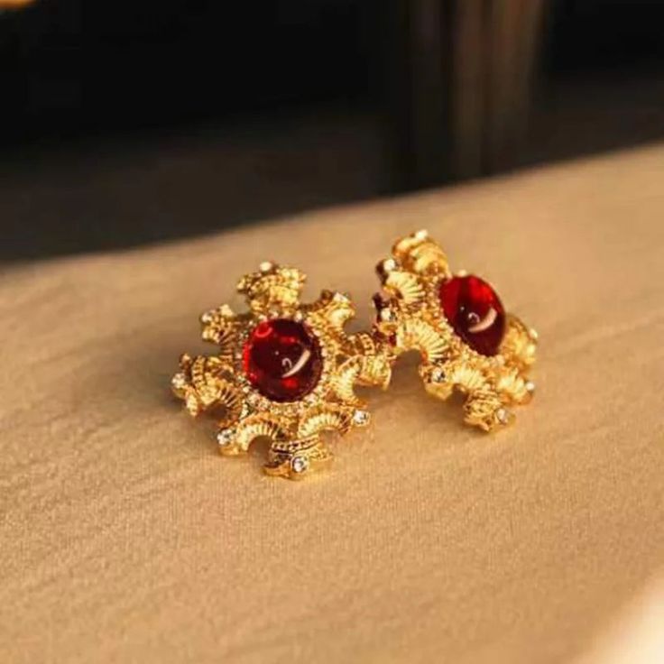 Vintage Red Color Resin Earrings Step into the spotlight with our stunning Vintage Red Color Resin Earrings. Crafted for the modern woman who appreciates the charm of vintage aesthetics, these earrings are a perfect blend of elegance and bold style. Unique Features: Timeless Design: The vintage-inspired design adds a touch of nostalgia and sophistication to any outfit. Quality Materials: Made from high-quality resin, these earrings are lightweight yet durable, ensuring comfort all day long. Vibr Elegant Red Earrings For Party, Elegant Red Jewelry With Matching Earrings, Classic Red Earrings For Party, Gold Ruby Earrings For Evening, Red Metal Earrings For Anniversary, Elegant Ruby Earrings, Red Metal Earrings For Evening, Elegant Red Drop Earrings, Elegant Red Metal Jewelry