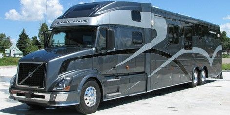 a large gray bus parked in a parking lot