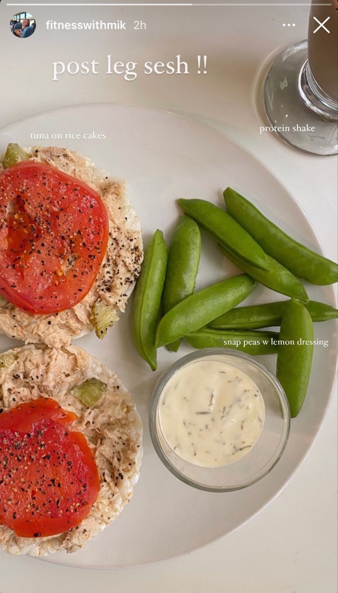 a white plate topped with two sandwiches and green beans