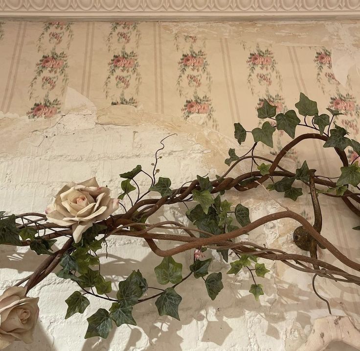 an arrangement of vines and flowers on a wall