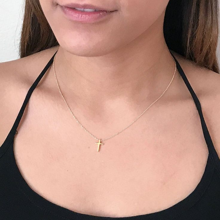 This tiny gold cross necklace is a classic addition to your layering necklaces. This minimalist necklace is also perfect by itself. - The cross charm is gold plated over sterling silver and measures approximately 12 mm in length or 1/2 inch. The dainty chain is 14k gold fill. This cross necklace is available in lengths from 14 - 20 inches. The model is wearing a 16 inch length. - Your new tiny cross necklace will come in a box, ready for gift giving. More Christian jewelry https://www.etsy.com/s Simple Yellow Gold Cross Necklace, Dainty Cross Necklace With Delicate Chain For Everyday, Dainty Cross Necklace For Everyday Wear, Minimalist Cross Charm Necklace With Delicate Chain, Dainty Yellow Gold Cross Necklace For Everyday, Dainty Everyday Cross Necklace With Delicate Chain, Minimalist Charm Necklace With Cross Pendant And Adjustable Chain, Everyday Cross Charm Necklace With Clavicle Chain, Minimalist Charm Necklace With Cross Pendant