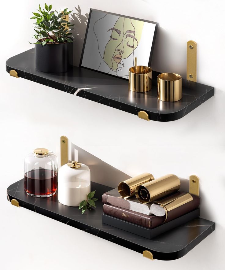 two black shelves with gold handles and vases on them