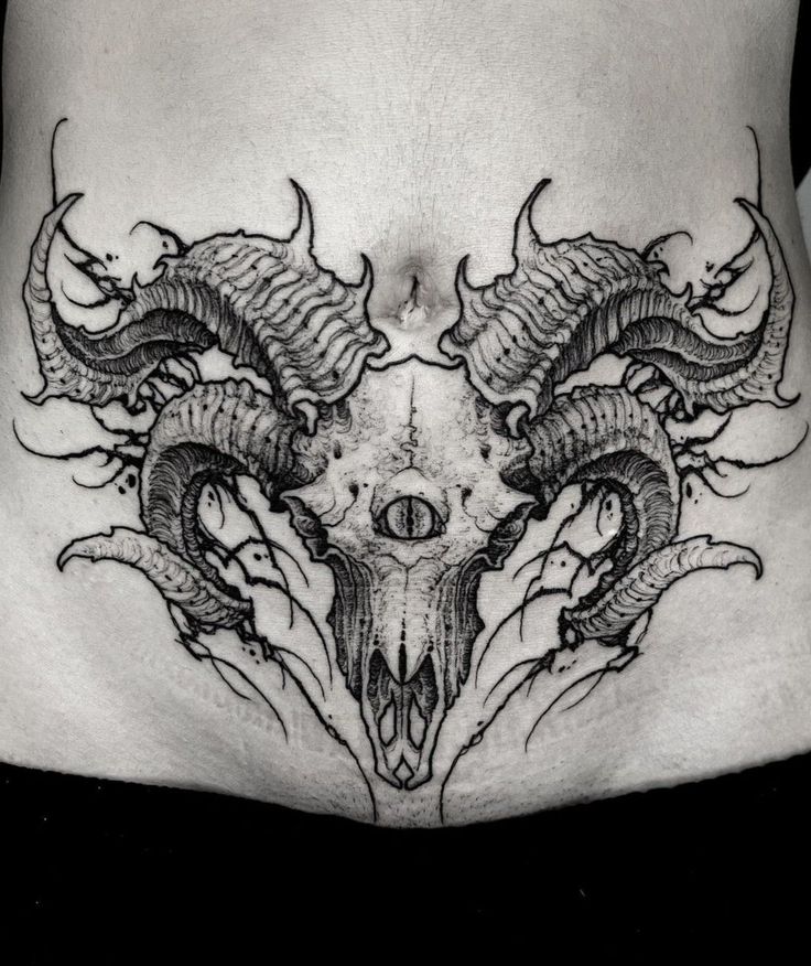 a black and white photo of a woman's stomach with dragon tattoos on it