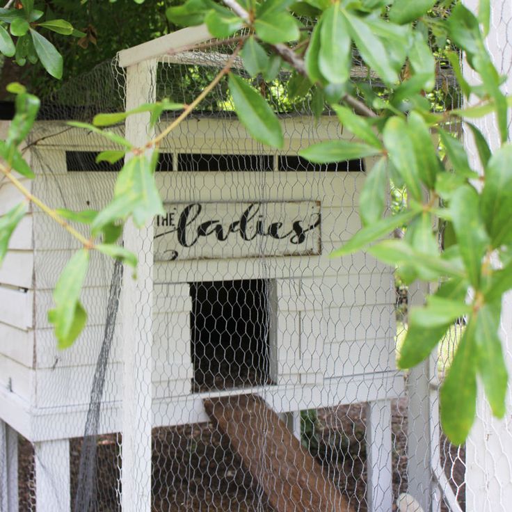 a white chicken coop with the word eaties written on it