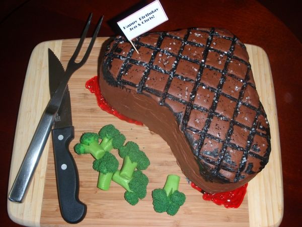 a steak and broccoli on a cutting board with a knife next to it