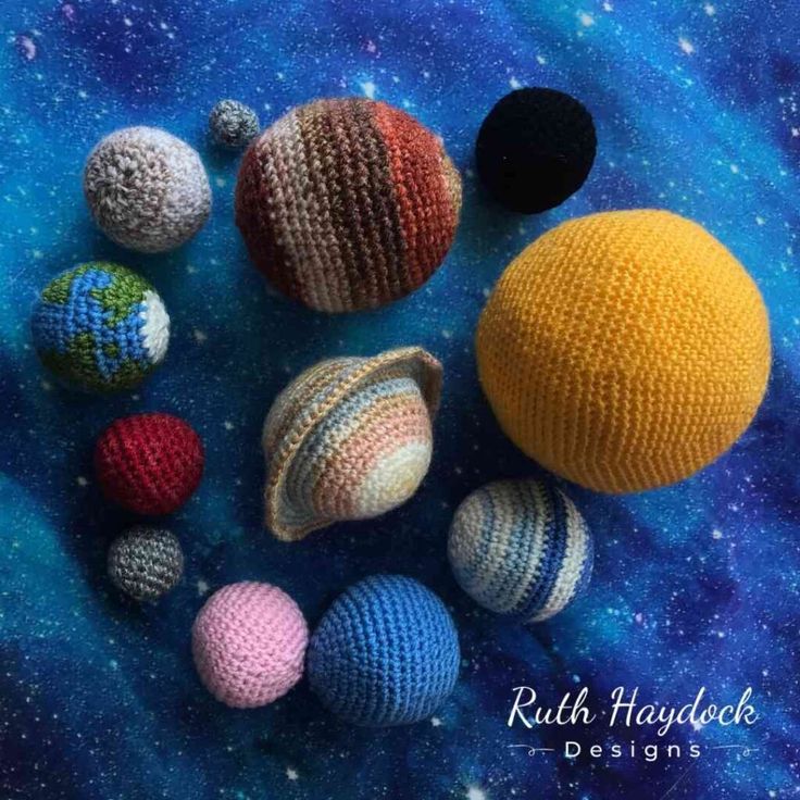 crocheted balls and planets on a blue background