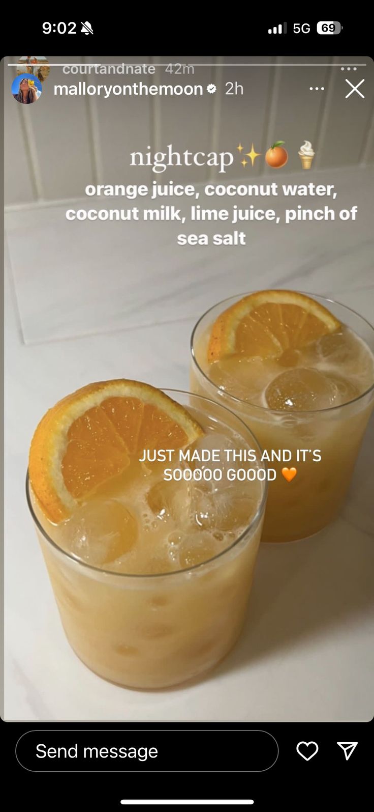 two glasses filled with orange juice sitting on top of a white counter next to each other