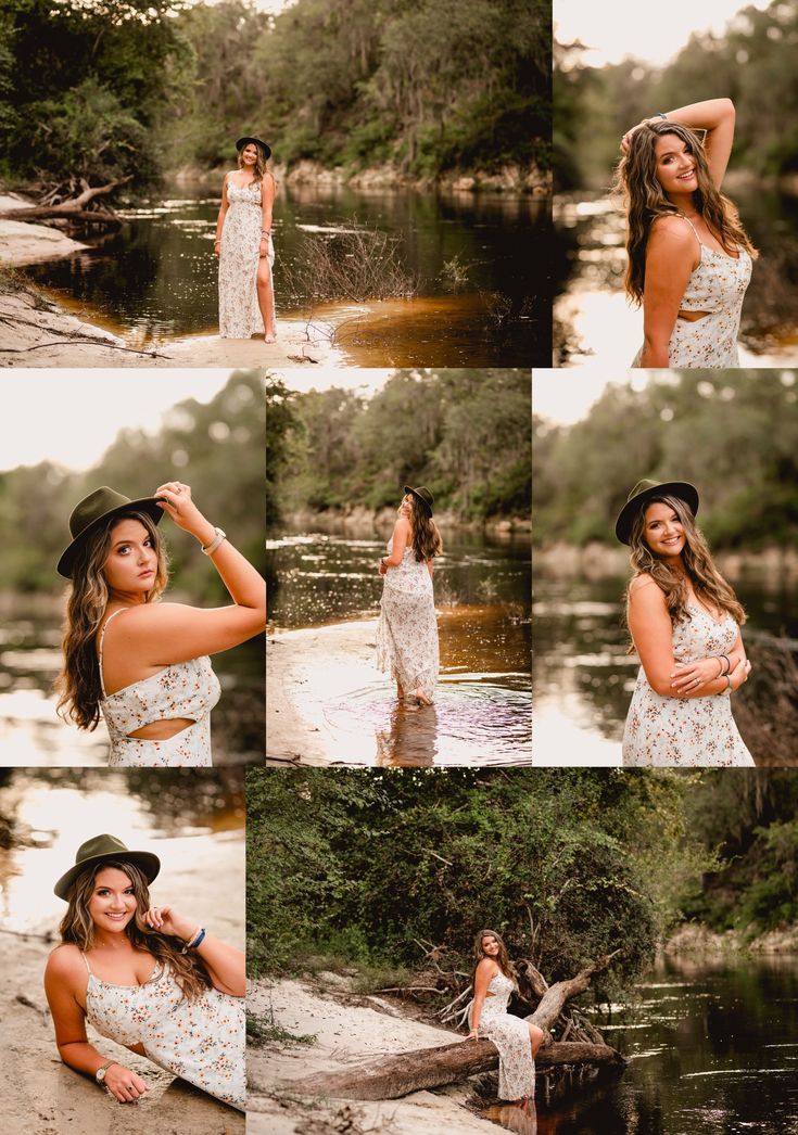 a woman in a white dress and black hat posing by the water with her hands on her head