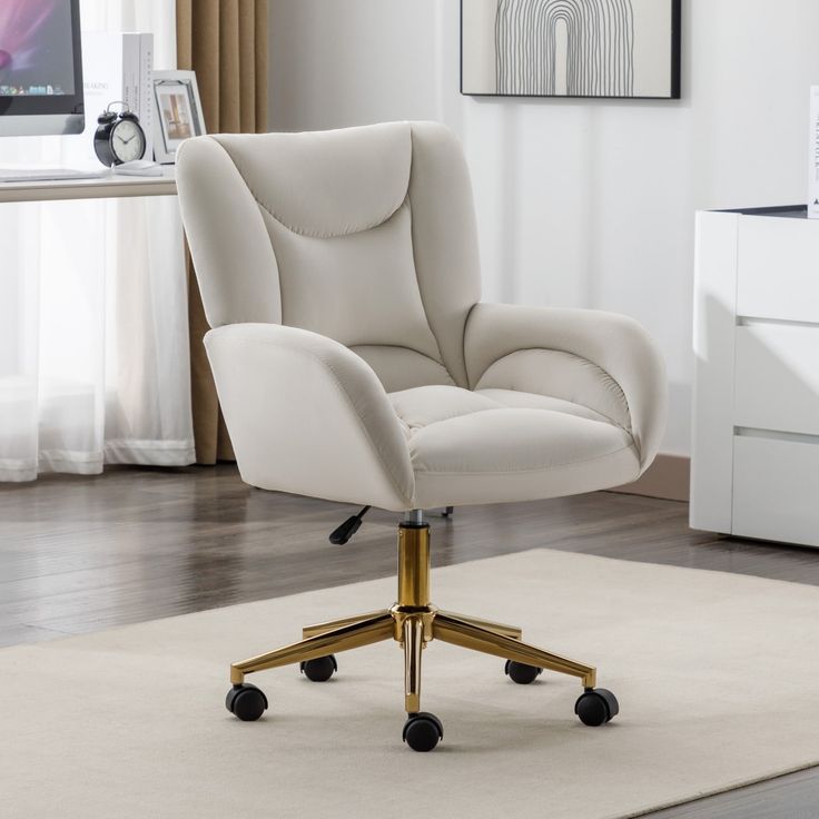 a white office chair sitting on top of a rug in front of a computer desk